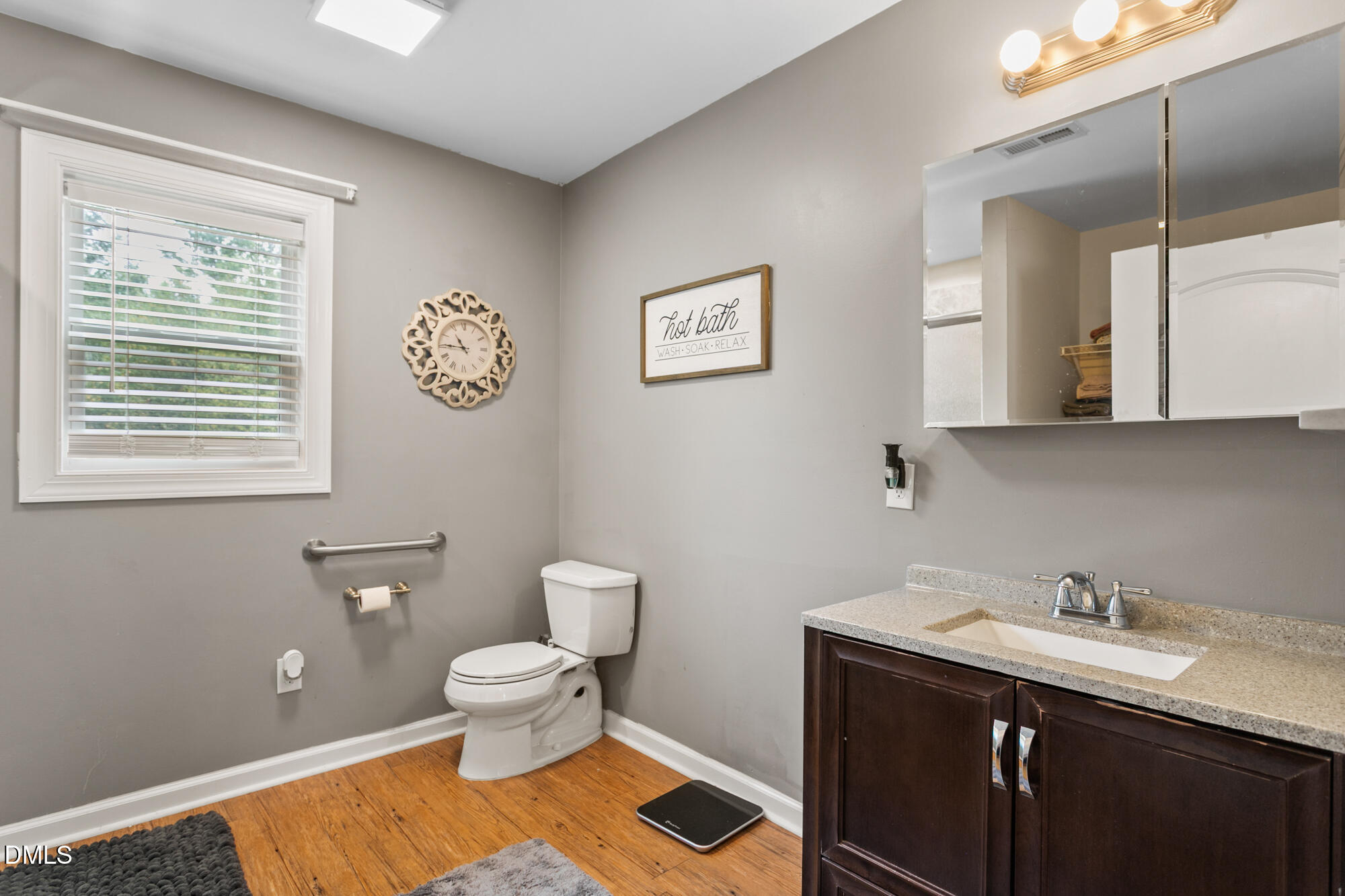 3163 Saul Loop Road Elon, NC 27244 - Photo 31 of 44 a bathroom with a toilet a sink and mirror
