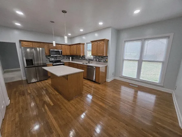 a bathroom with a tub a sink and shower