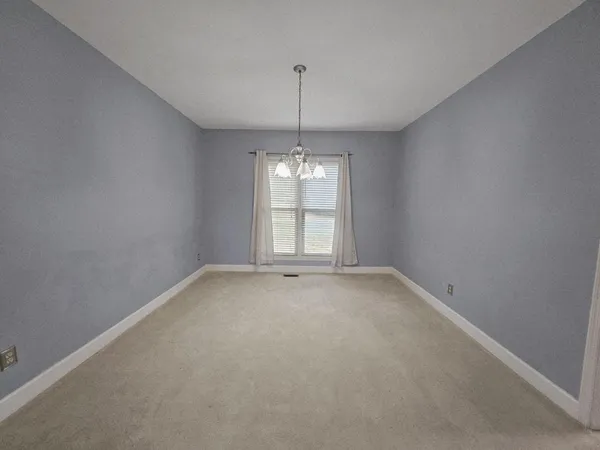 a view of a chandelier in big room and chandelier in a room