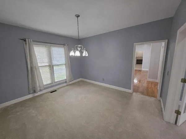 a view of porch with furniture and floor to ceiling window