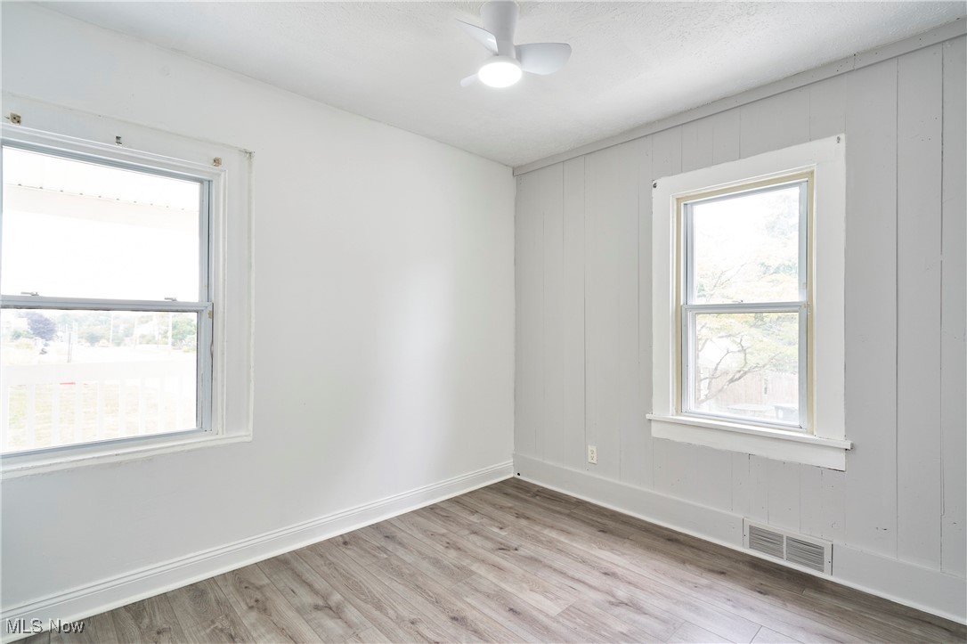 1001 Dayton Street Akron, OH 44310 - Photo 12 of 27 Bedroom 1 with Fresh paint,LVT flooring and new ceiling fan