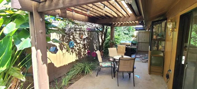 an outdoor sitting area with furniture and garden view