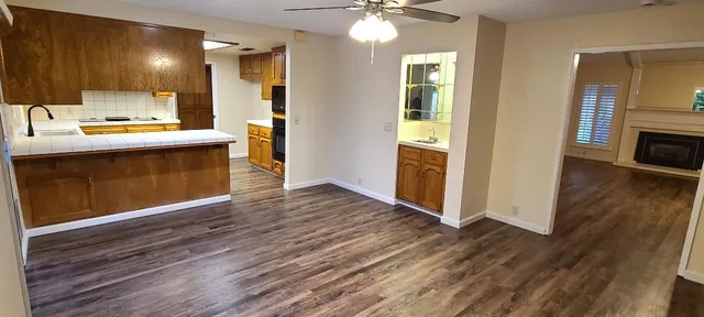 a hallway with a sink and a large window with wooden floor