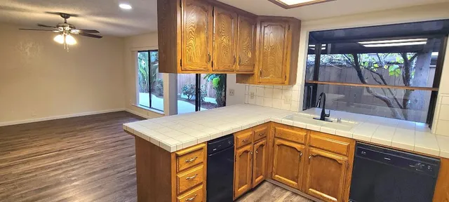 a kitchen with wooden cabinets and a stove top oven