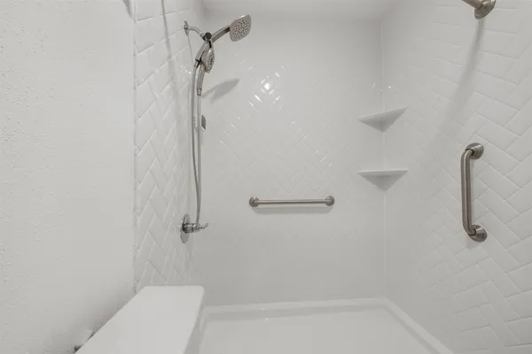 a bathroom with a shower and toilet