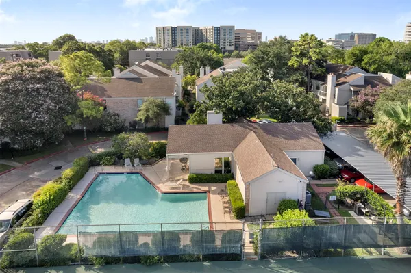 an aerial view of residential houses with outdoor space and swimming pool