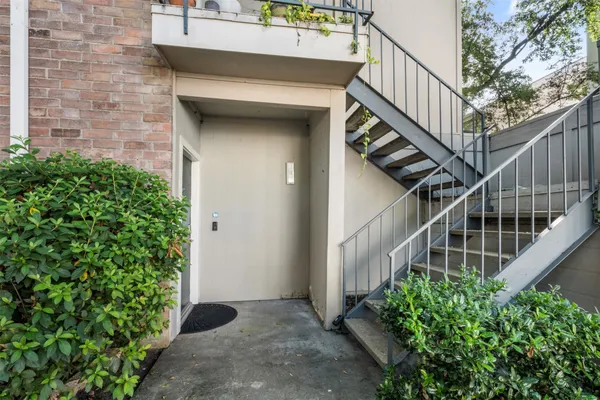 a view of a pathway of a house with wooden floor and fence