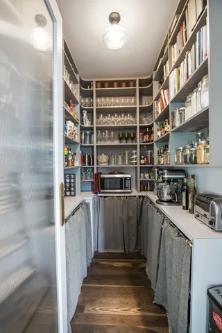 a view of a kitchen with shelves