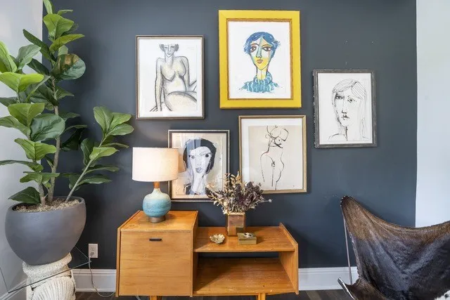 a dining room with furniture and potted plant