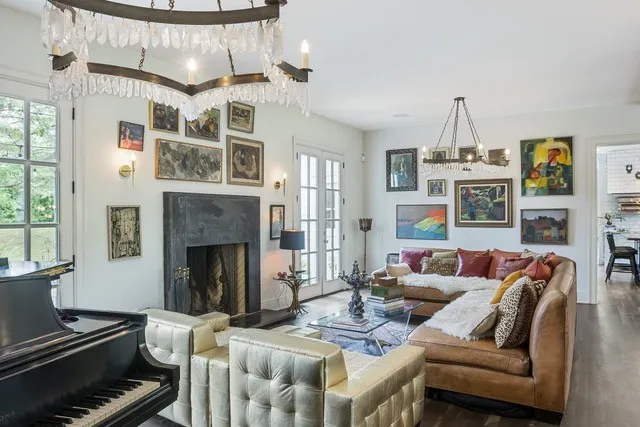 a living room with furniture fireplace and a chandelier