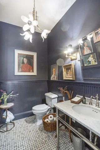 a bathroom with a sink a toilet and a mirror