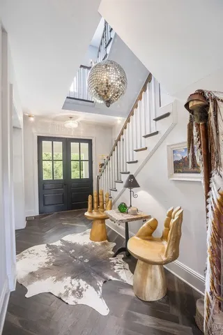 a view of a livingroom with furniture wooden floor and a chandelier