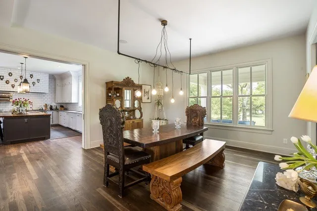 a dining room with furniture a chandelier and wooden floor