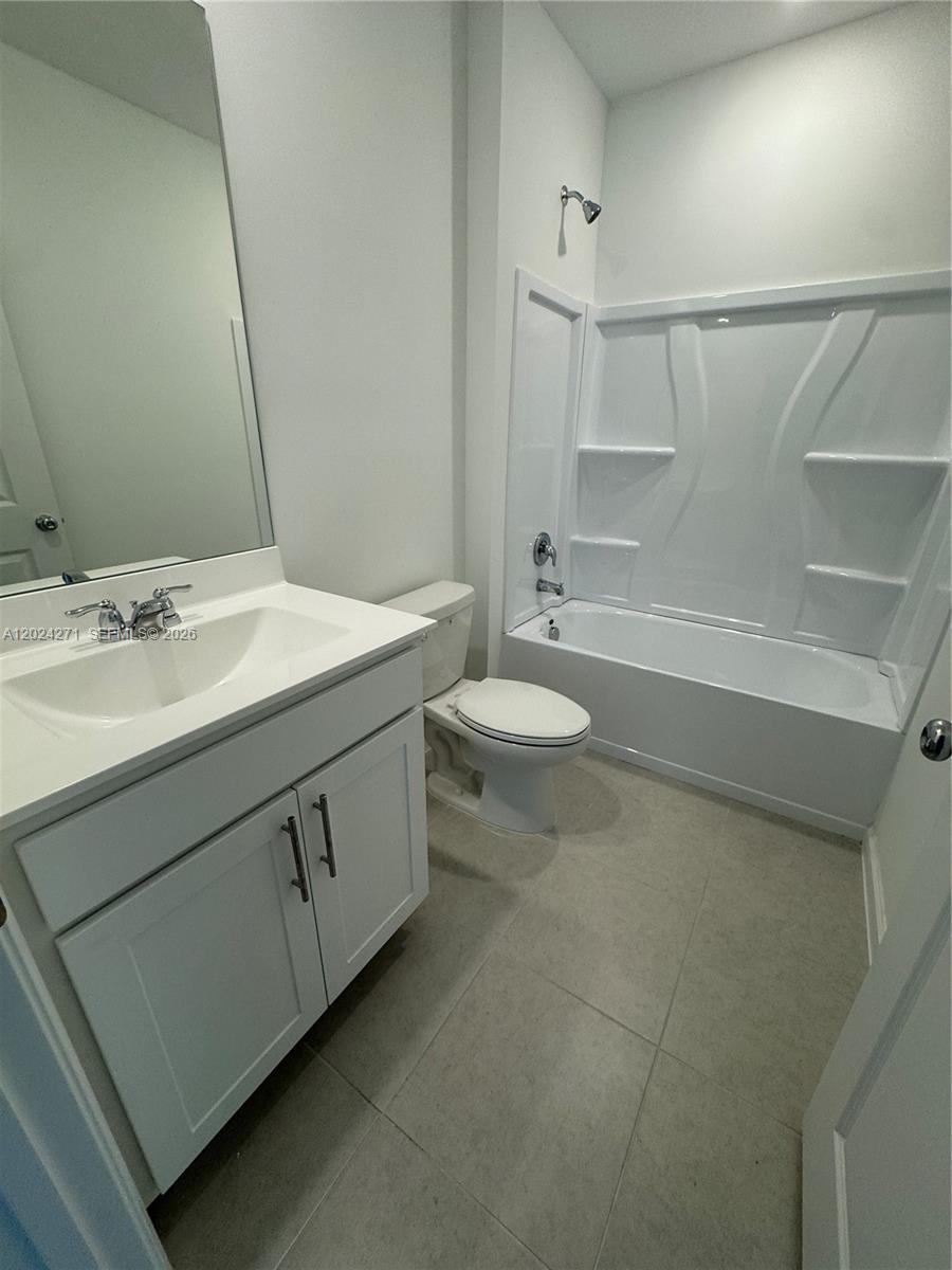 693 Carlyle Way Fort Pierce, FL 34947 - Photo 16 of 19 a bathroom with a sink a toilet and shower