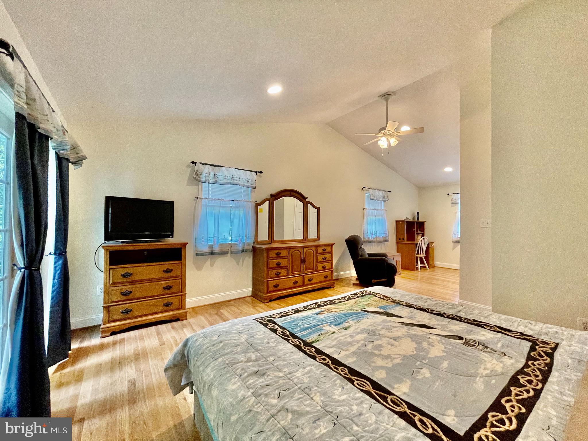 1270 Calvert Beach Road St. Leonard, MD 20685 - Photo 12 of 31 a bedroom with furniture and flat screen tv