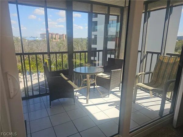 a view of a living room with a floor to ceiling window