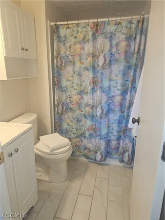 a bathroom with a shower and a toilet