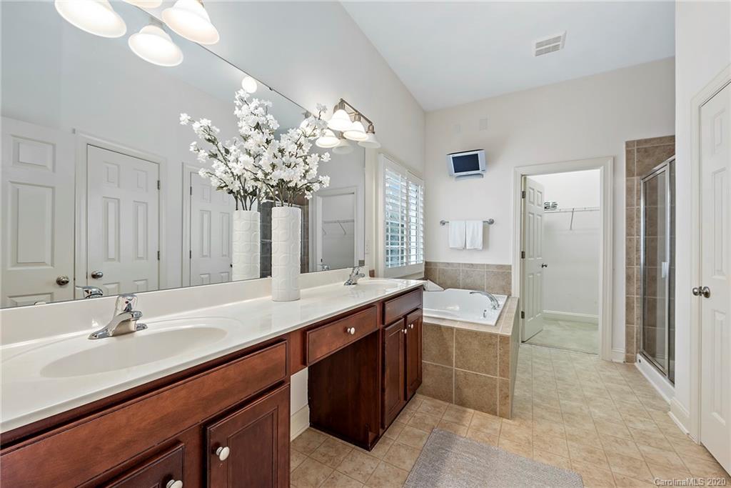 527 Fourth Baxter Crossing Fort Mill, SC 29708 - Photo 16 of 27 a spacious bathroom with a sink double vanity granite and a mirror