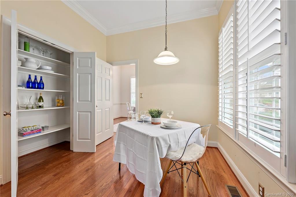 527 Fourth Baxter Crossing Fort Mill, SC 29708 - Photo 10 of 27 a view of a dining room with furniture a chandelier and wooden floor