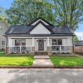 a front view of a house with a yard table and chairs