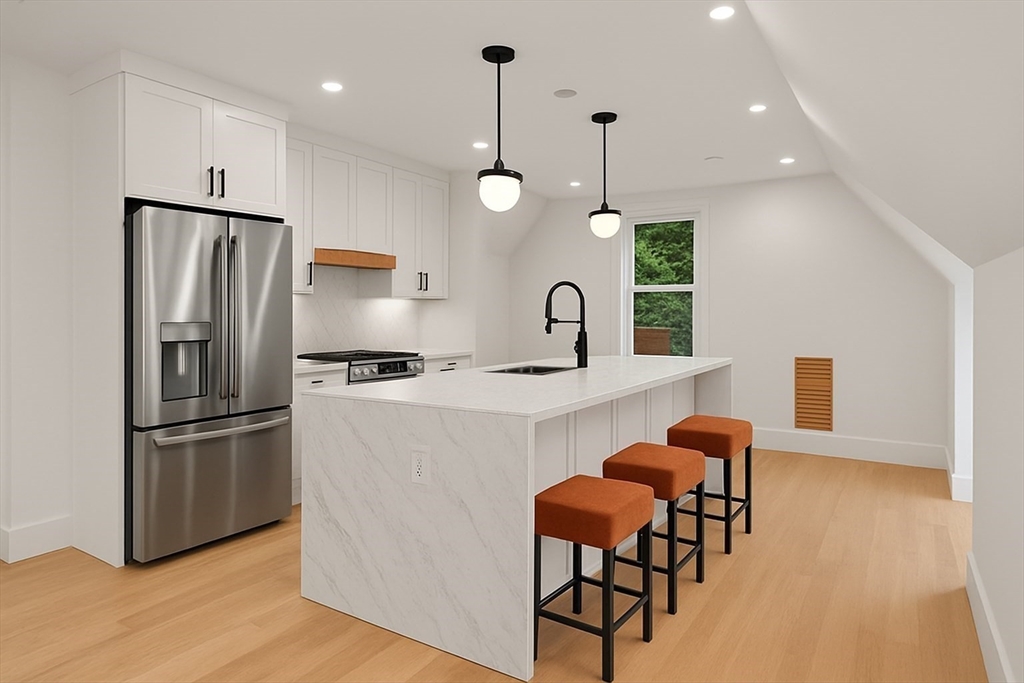 20 Boylston Street, Unit 3 Jamaica Plain, MA 02130 - Photo 3 of 12 a kitchen with stainless steel appliances a refrigerator a sink a stove a dining table and chairs with wooden floor