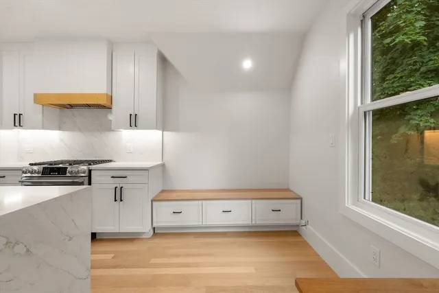 a kitchen with a stove and a window