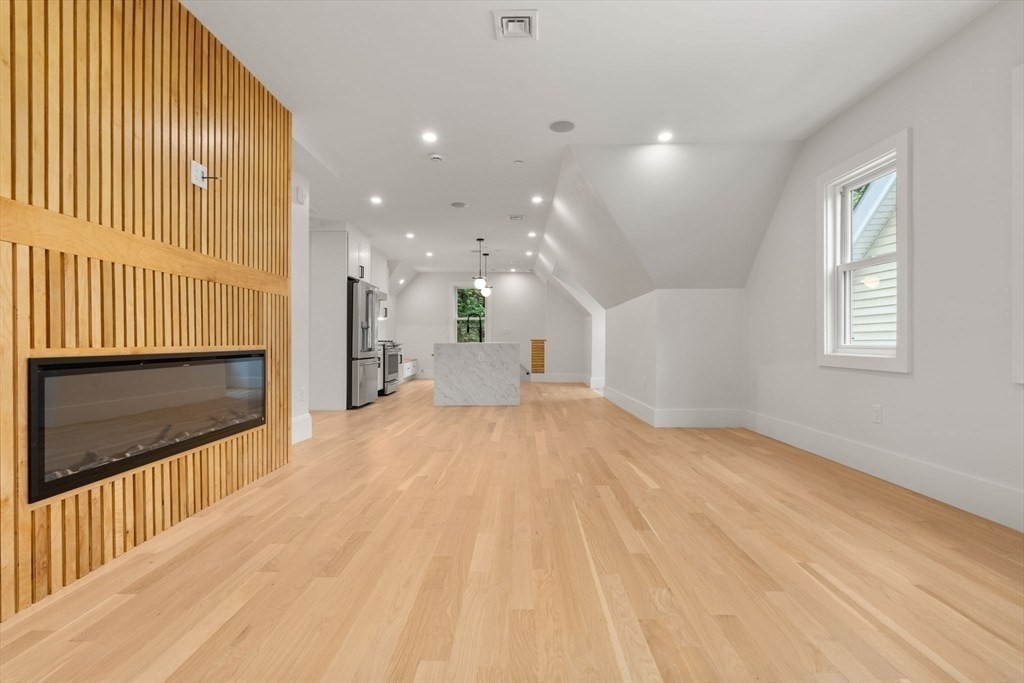 20 Boylston Street, Unit 3 Jamaica Plain, MA 02130 - Photo 6 of 12 a view of empty room with wooden floor and fireplace
