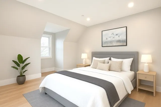 a bedroom with a bed and a potted plant