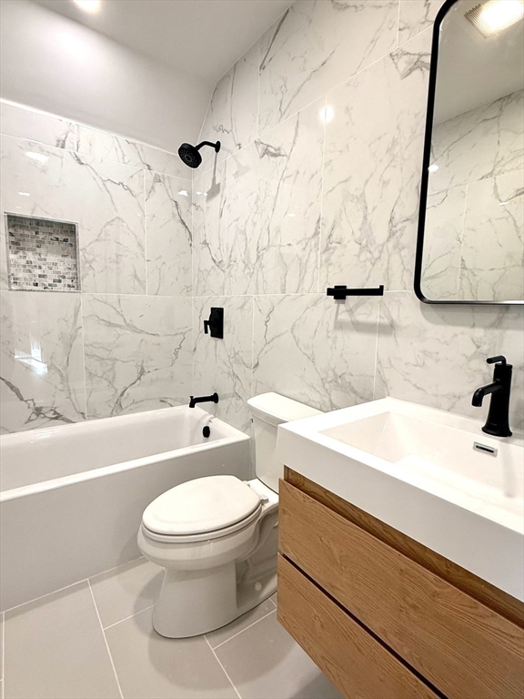 20 Boylston Street, Unit 3 Jamaica Plain, MA 02130 - Photo 10 of 12 a bathroom with a sink a toilet and shower