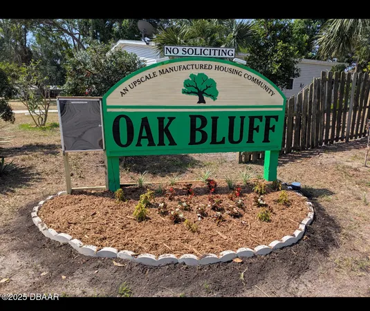 a wooden sign with a bench and yard