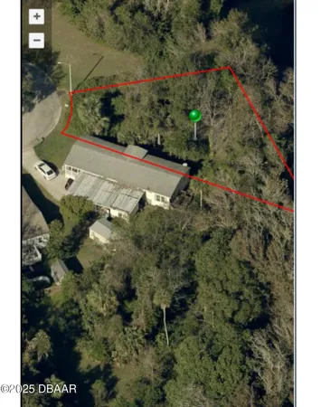 an aerial view of a house with a yard