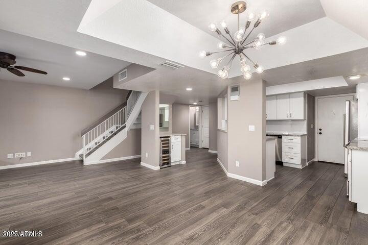 3030 North Hayden Road, Unit 16 Scottsdale, AZ 85251 - Photo 3 of 30 a view of an empty room with wooden floor and a ceiling fan