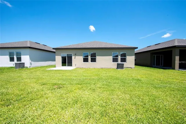 a view of a house with a yard and front view