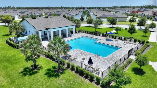 aerial view of a house with pool and a yard