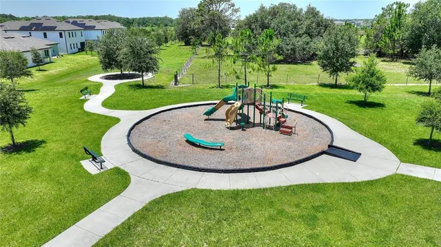 an aerial view of a house with a yard