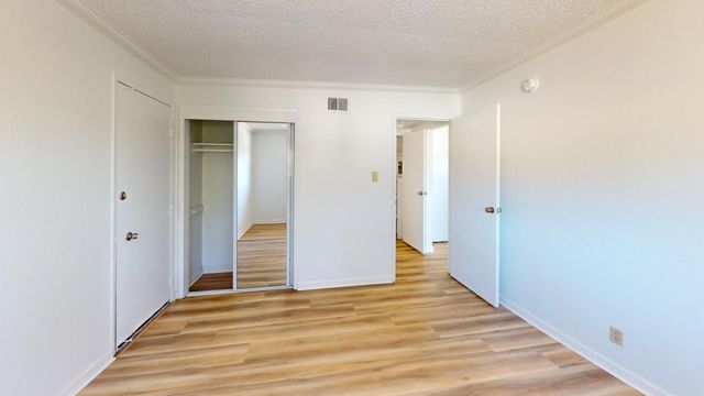 a view of a hallway with wooden floor and entryway