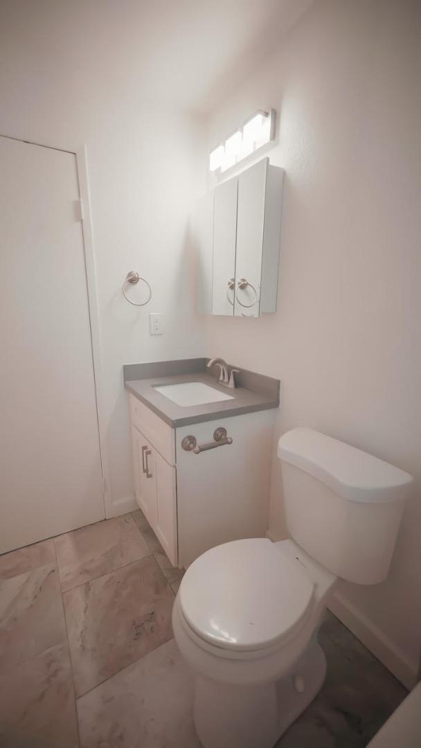 7 Merrydale Road San Rafael, CA 94903 - Photo 9 of 14 a white toilet sitting next to a bathroom sink and vanity
