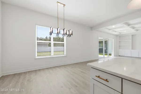 a view of kitchen with furniture and a chandelier