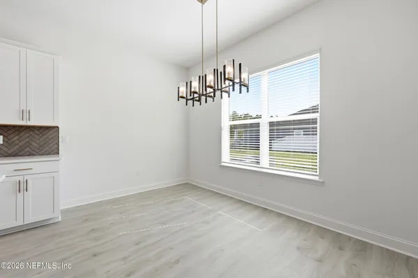 a kitchen with stainless steel appliances granite countertop a sink a stove and a wooden floor