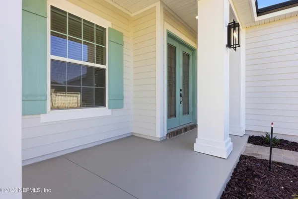 a view of house with porch and wooden floor