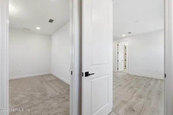 a bathroom with a granite countertop toilet and a sink