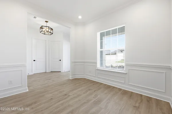 a room with a sink cabinets and a window