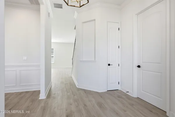 a view of hallway with wooden floor
