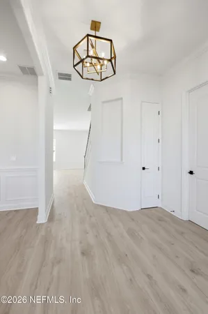 a view of a room with wooden floor and white walls