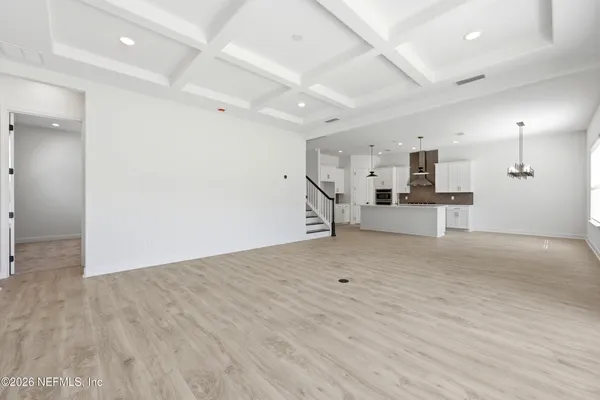 a view of a kitchen with a sink and a refrigerator