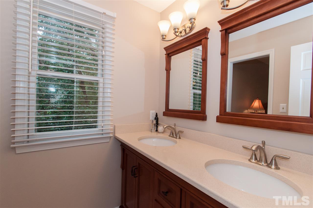 1316 October Road Raleigh, NC 27614 - Photo 15 of 25 a bathroom with a sink vanity and a mirror