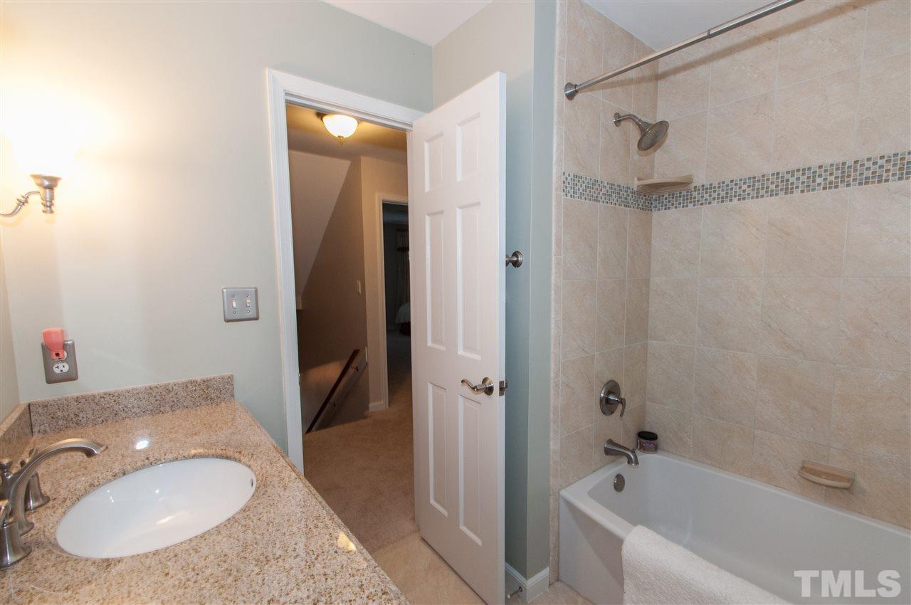 1316 October Road Raleigh, NC 27614 - Photo 16 of 25 a bathroom with a sink toilet and shower