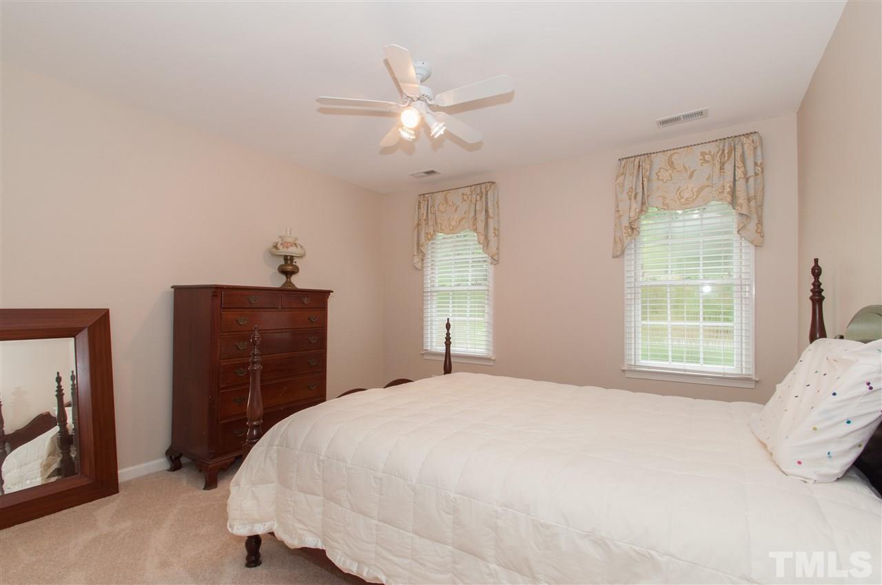 1316 October Road Raleigh, NC 27614 - Photo 17 of 25 a bedroom with a bed and a window