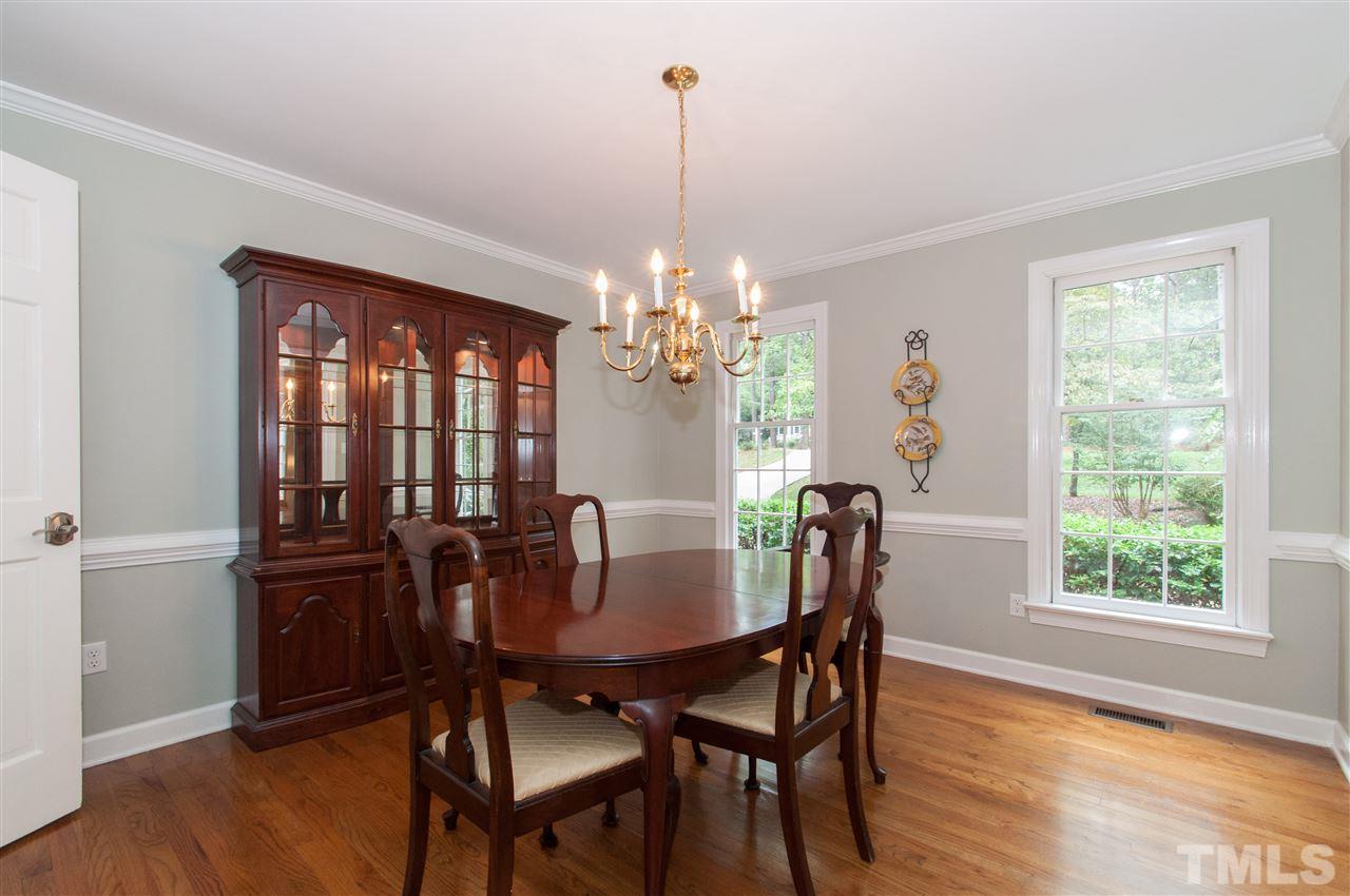1316 October Road Raleigh, NC 27614 - Photo 3 of 25 a dining room with furniture a chandelier and wooden floor