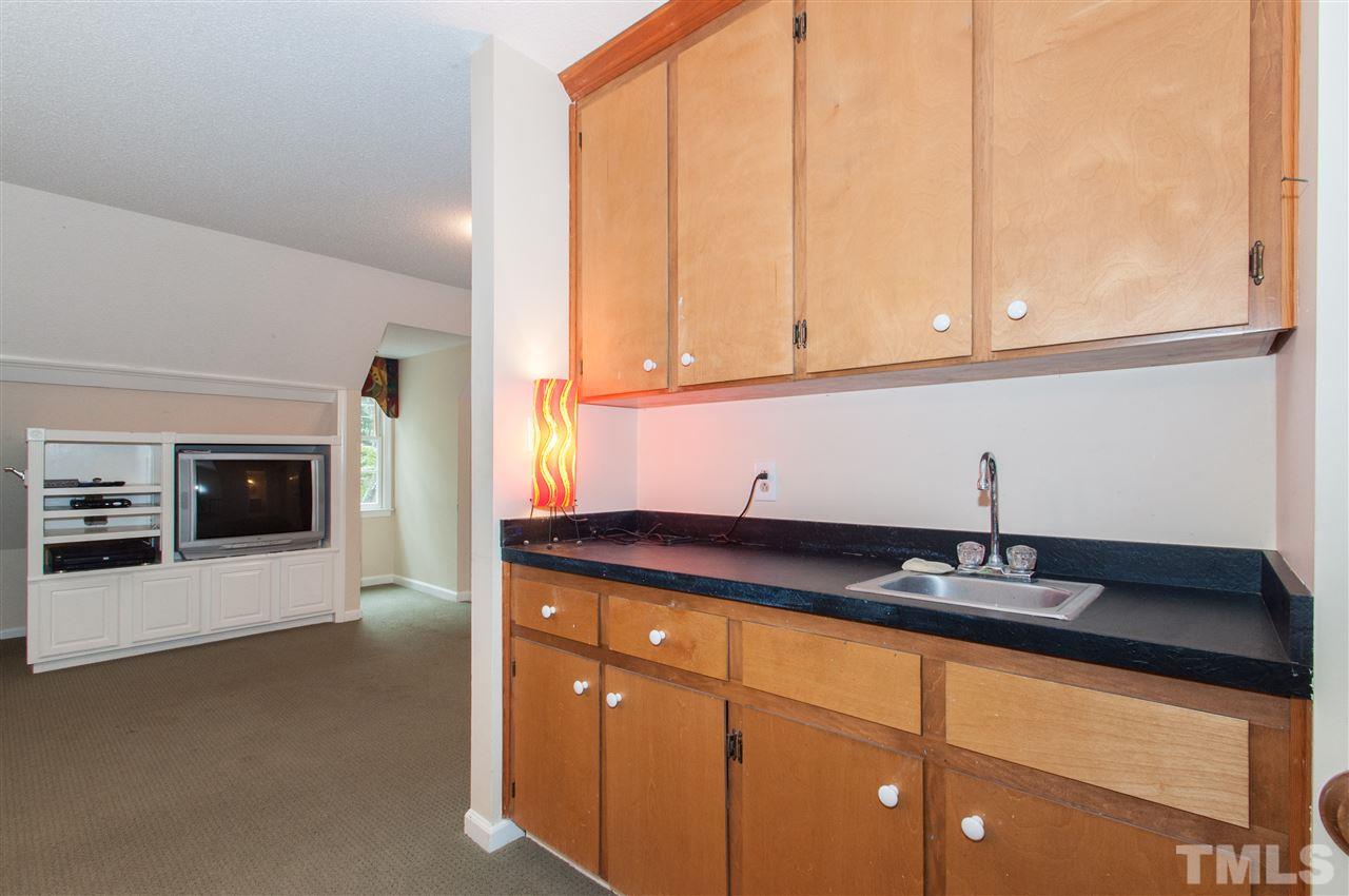 1316 October Road Raleigh, NC 27614 - Photo 23 of 25 a kitchen with granite countertop a sink and a stove top oven